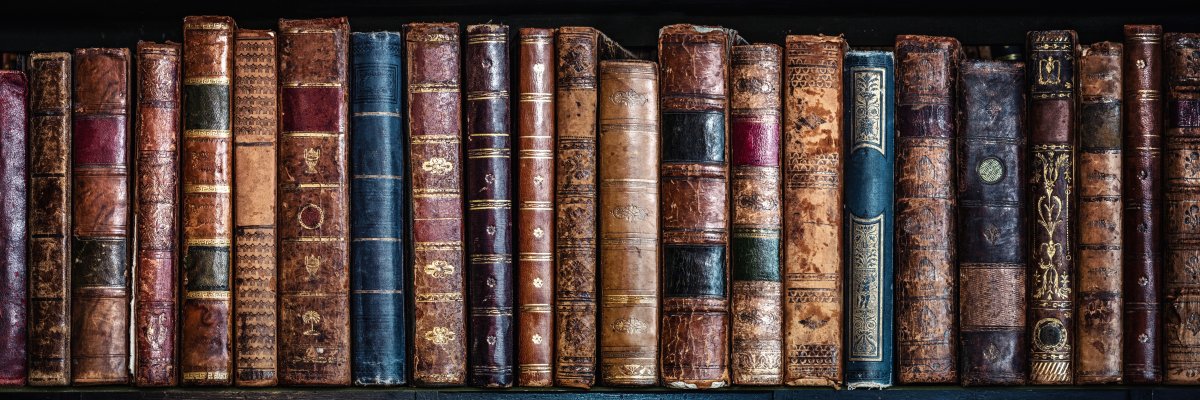 Old books on wooden shelf. Tiled Bookshelf background. Concept on the theme of history, nostalgia, old age. Retro style. Old books on wooden shelf. Tiled Bookshelf background. Concept on the theme of history, nostalgia, old age. Retro style.