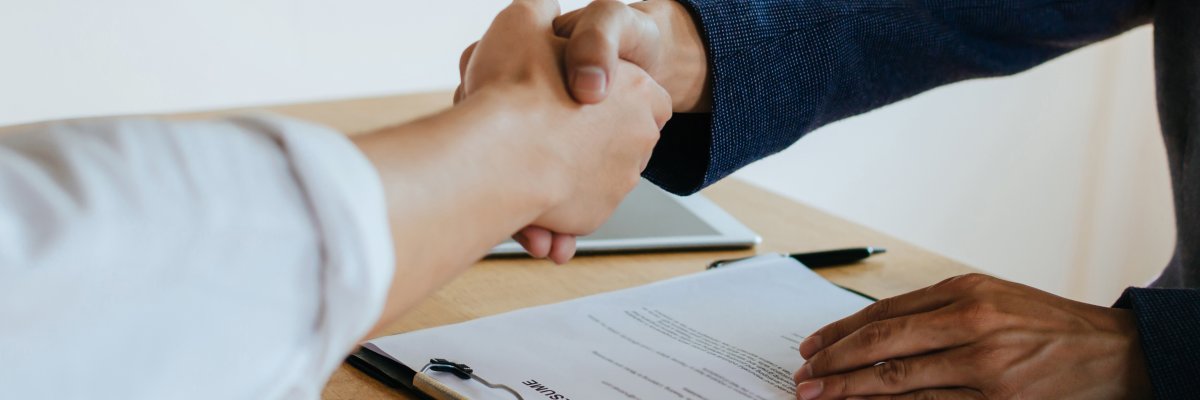Partnership. two business people shaking hand after business signing contract in meeting room at company office, job interview, investor, success, negotiation, partnership, teamwork, financial concept