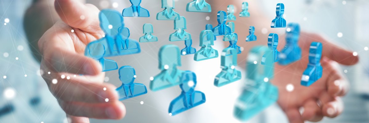 Businessman holding 3D rendering group of blue people Businessman holding 3D rendering group of blue people